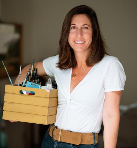 Sylvan holding a box of paint supplies